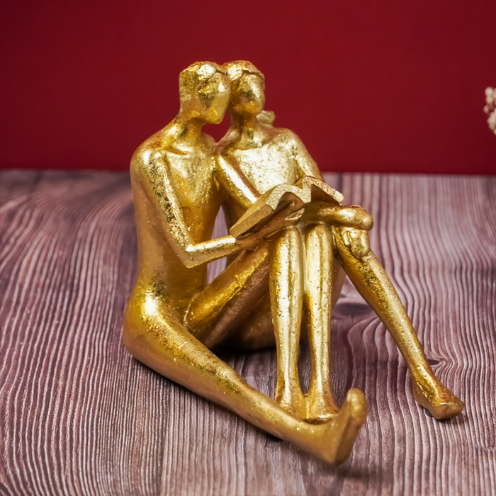 Golden Couple Reading Book Sculpture